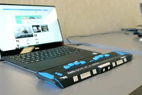 Assistive equipment connected to a laptop on a table.
