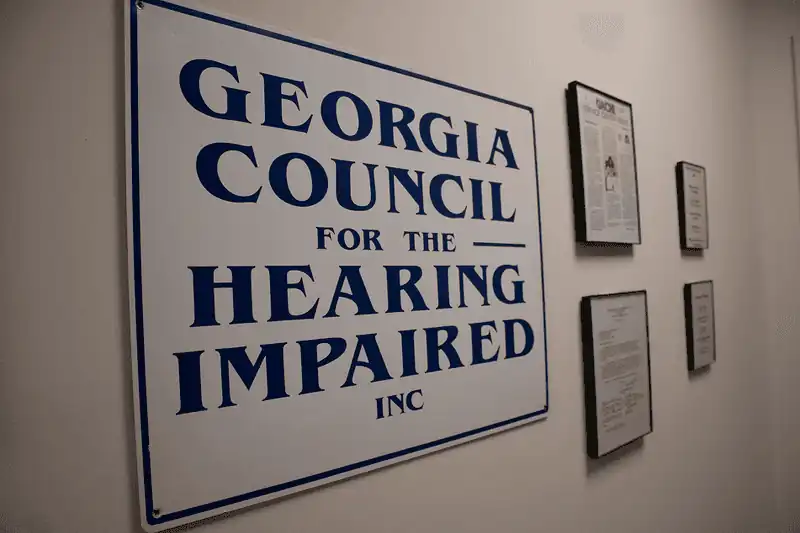Georgia Council for the Hearing Impaired, Inc. sign on a wall.
